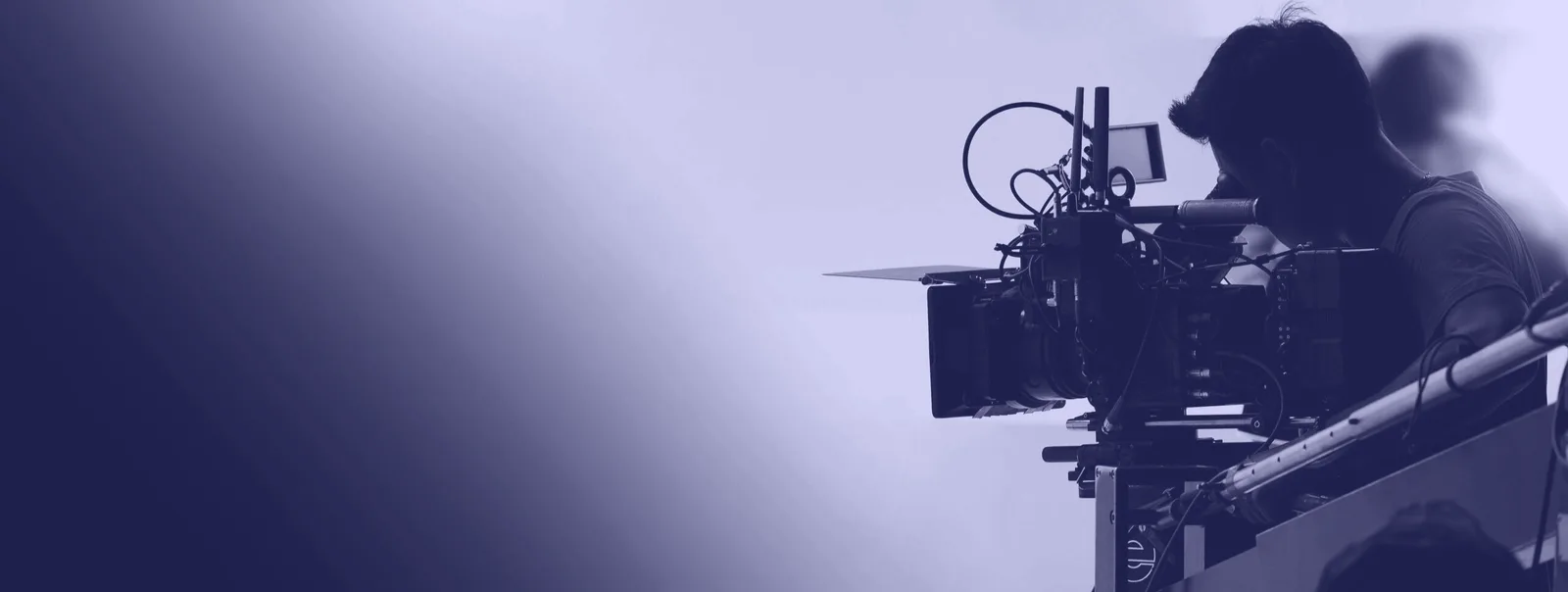 A camera operator filming in a studio